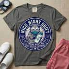 A humorous graphic for a Neonatal Intensive Care Unit featuring a circular design with an illustration of a tired raccoon wearing a medical face mask and holding a baby bottle labeled 'NICU', surrounded by the text 'NICU NIGHT SHIFT' at the top and 'STAYING ALIVE ON PURE SPITE & CAFFEINE' at the bottom.