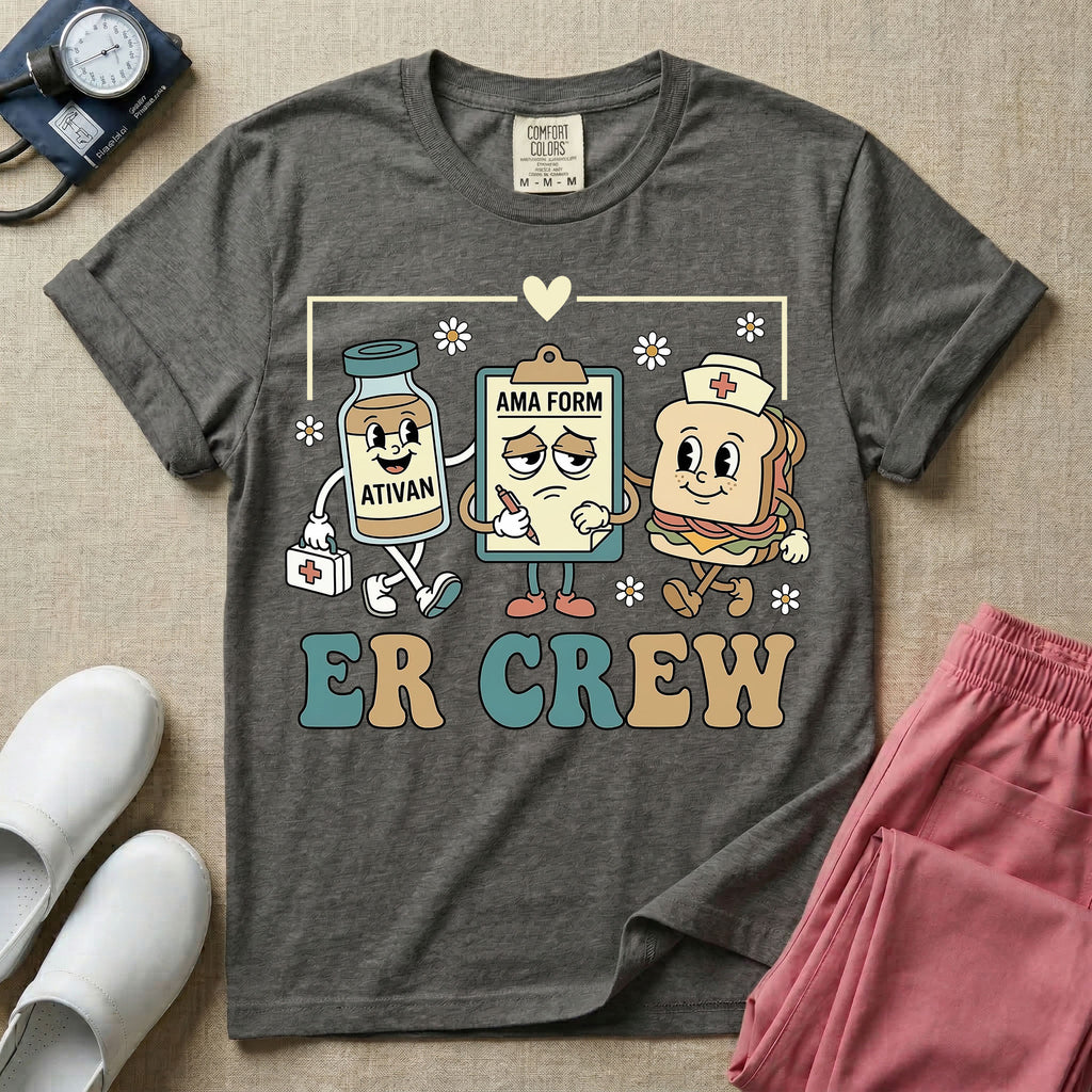 A retro-style t-shirt for emergency room nurses featuring the text "ER CREW" below a vintage cartoon illustration of a medicine bottle, a grumpy clipboard holding an AMA form, and a sandwich wearing a nurse cap walking together.