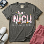Neonatal Intensive Care Unit NICU nursing t-shirt featuring the letters NICU in a pink plaid pattern with bunny ears on the I, alongside a basket and Easter eggs, positioned above the cursive text "Neonatal Intensive Care Unit Nurse".