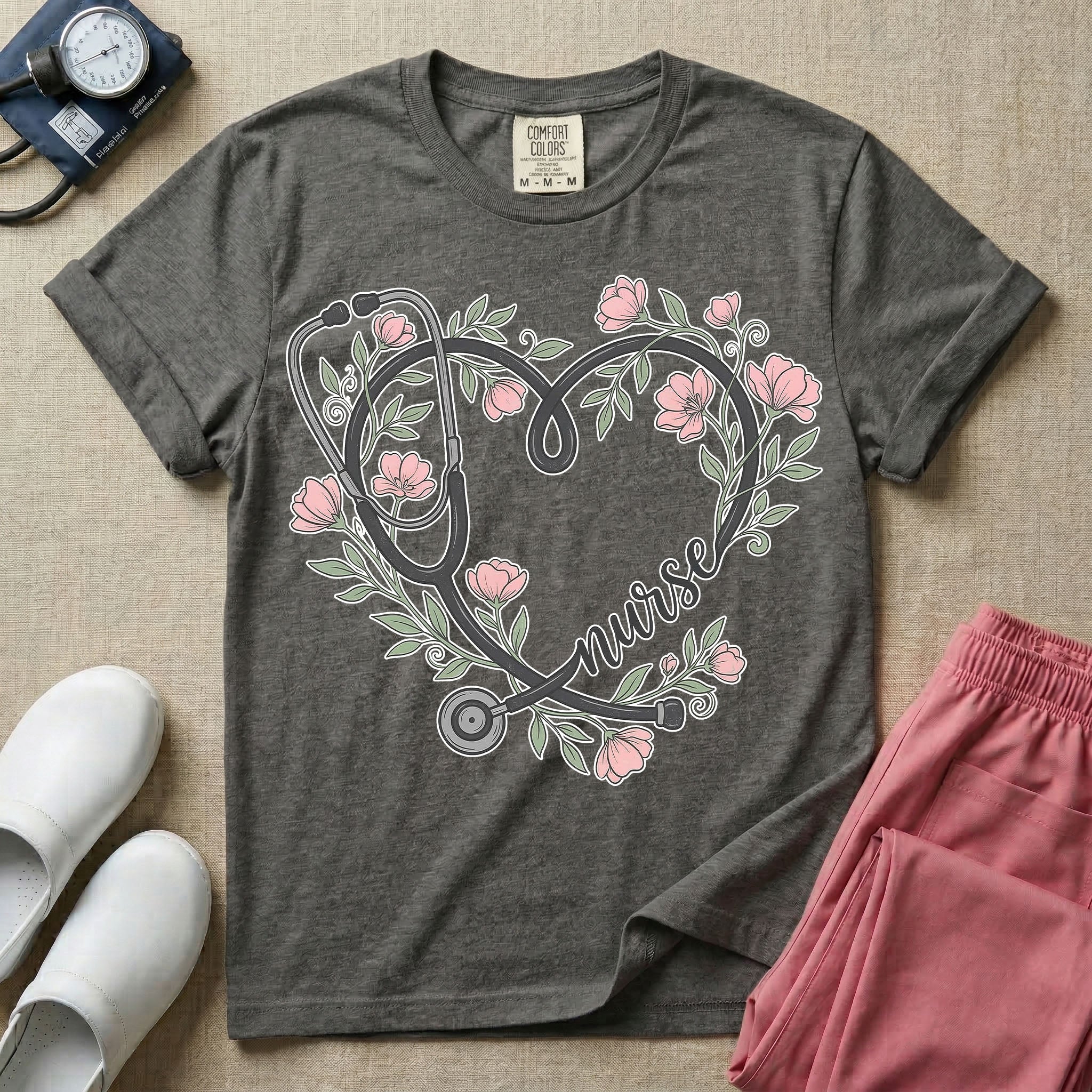 General nursing t-shirt featuring a heart-shaped stethoscope design intertwined with pink flowers and the cursive text "nurse".