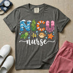 A cute t-shirt for NICU nurses featuring the text "NICU nurse" where the letters are designed with ocean elements like waves, seaweed, and a jellyfish, surrounded by under the sea creatures including a sea turtle, tropical fish, pufferfish, and starfish.