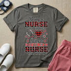 A t-shirt featuring the text Being a NURSE IS A CHOICE Being a RETIRED NURSE IS AN HONOR surrounding a central graphic of a red and black buffalo plaid heart intertwined with a stethoscope.