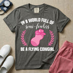 A humorous graphic tee for labor and delivery nurses featuring an illustration of a peanut ball wearing a cowboy hat, framed by laurel branches, along with the text "IN A WORLD FULL OF semi-fowlers BE A FLYING COWGIRL".
