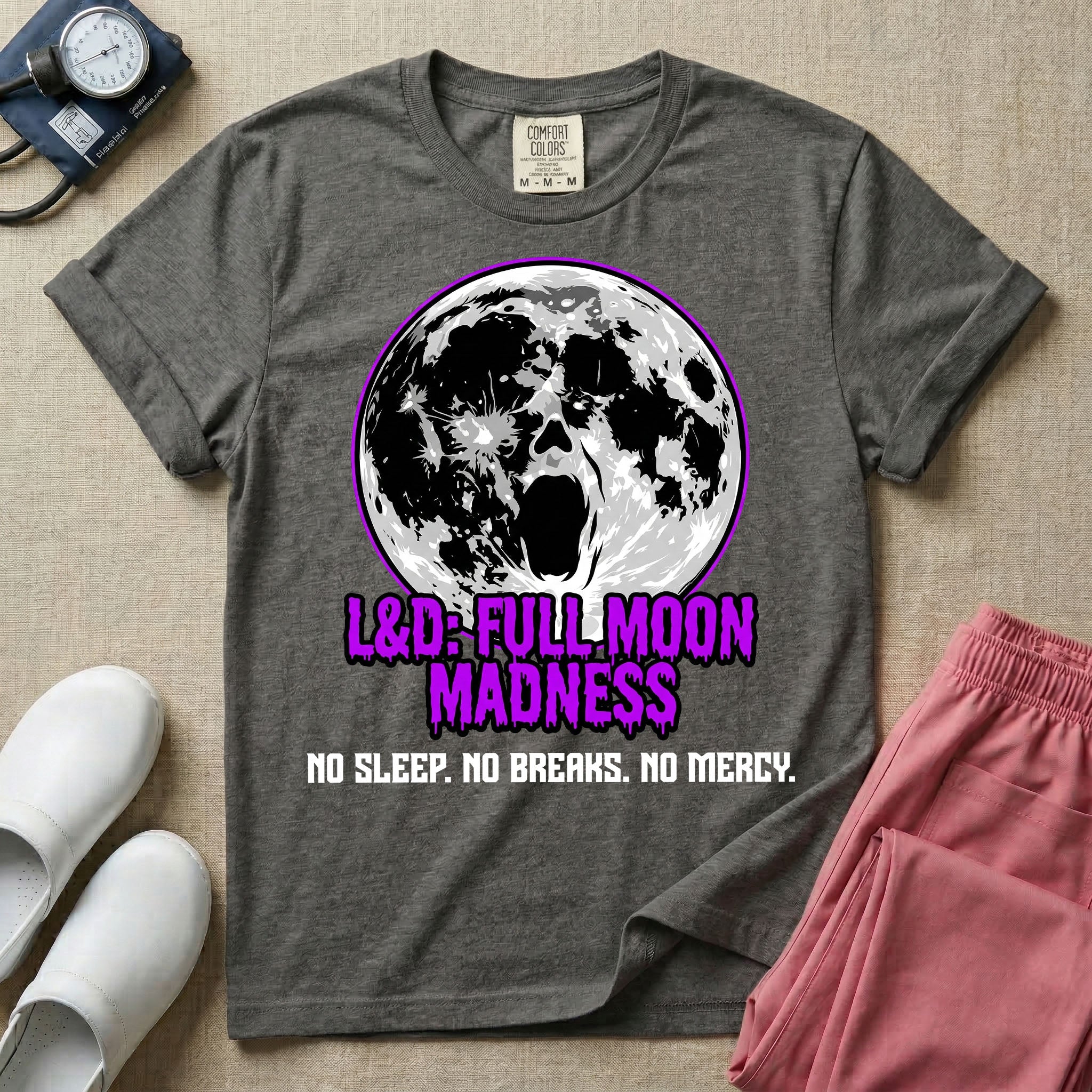 A humorous Labor and Delivery nurse graphic featuring a screaming face morphing out of a full moon, accompanied by purple dripping text that reads L&D: FULL MOON MADNESS and distressed black text below reading NO SLEEP. NO BREAKS. NO MERCY.