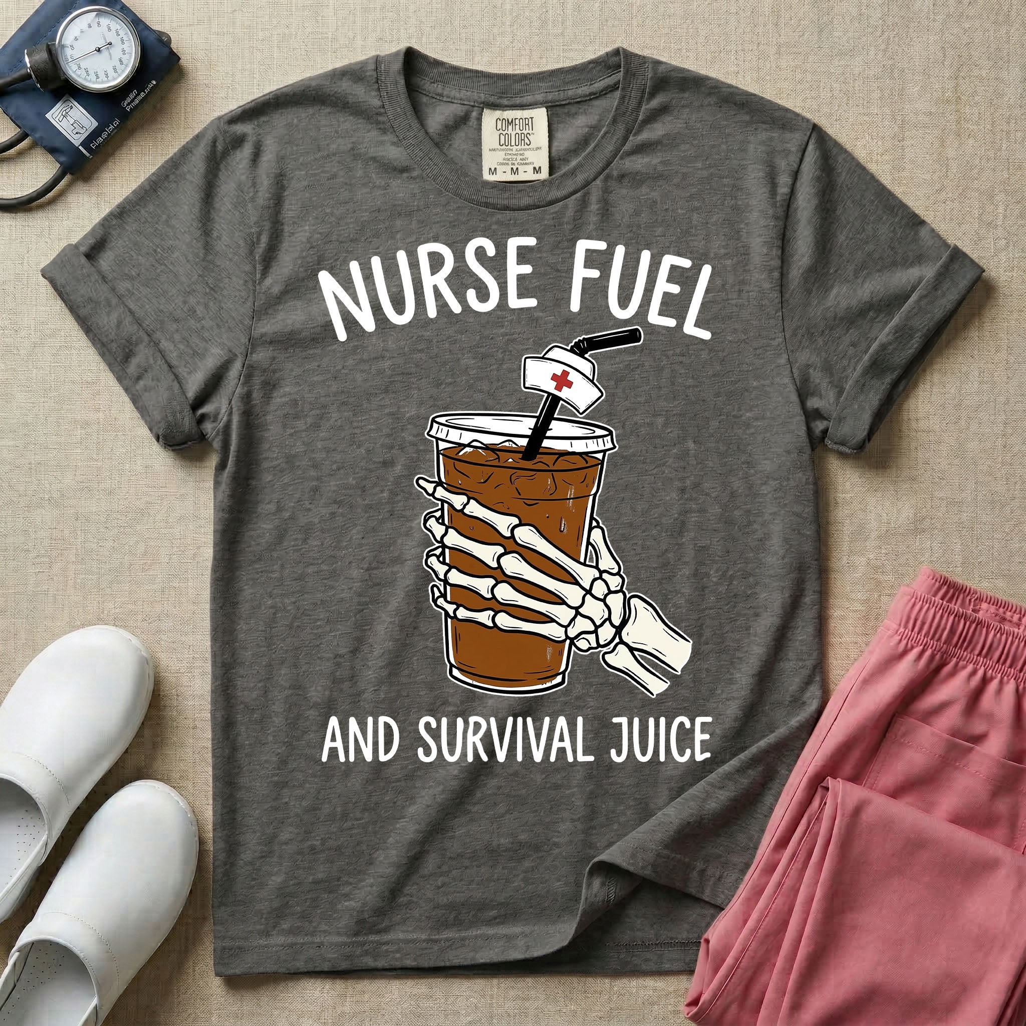 General nursing t-shirt featuring a graphic of a skeleton hand holding an iced coffee cup with a nurse cap on the straw and the text "NURSE FUEL AND SURVIVAL JUICE"