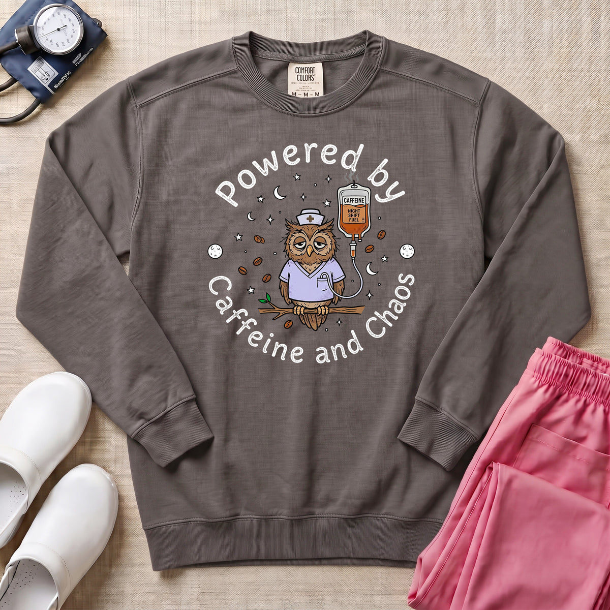 Powered By Caffeine And Chaos Night Shift Nurse Sweatshirt - Pepper Lifestyle Hero Mockup | HugTee