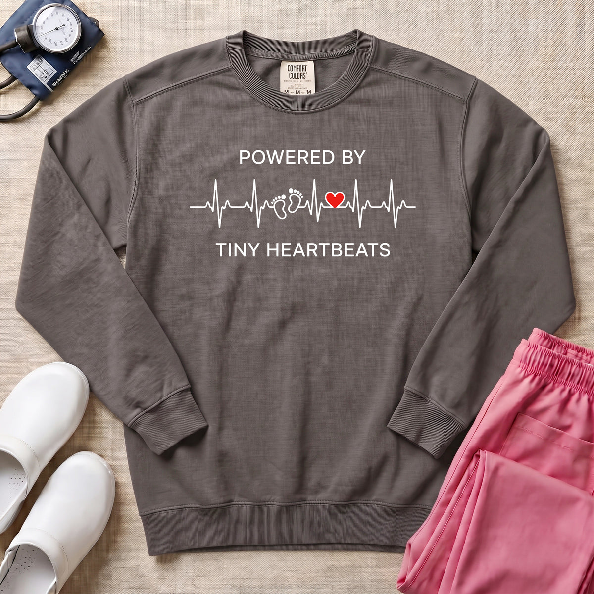 Powered By Tiny Heartbeats EKG Nurse Sweatshirt - Pepper Lifestyle Hero Mockup | HugTee