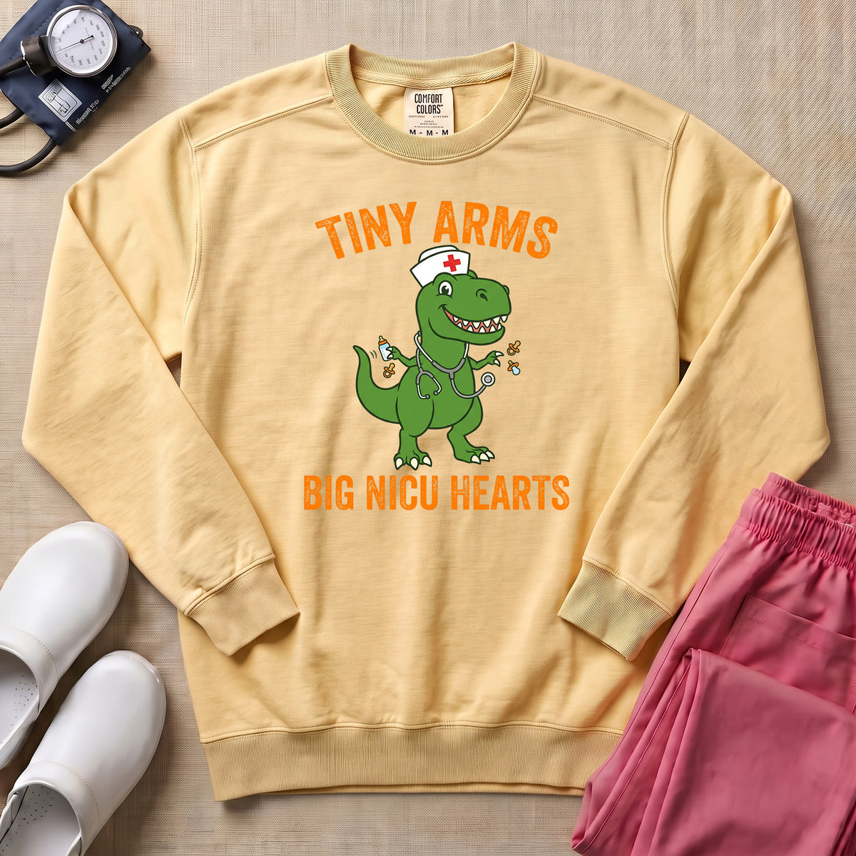 Tiny Arms Big NICU Hearts Funny T-Rex Nurse Sweatshirt - Butter Comfort Colors Sweatshirt | HugTee