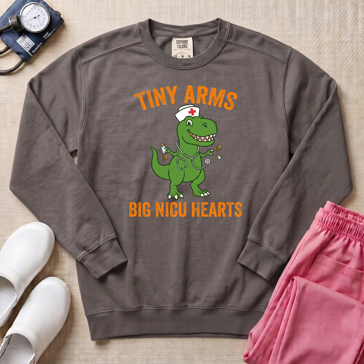 Tiny Arms Big NICU Hearts Funny T-Rex Nurse Sweatshirt - Pepper Lifestyle Hero Mockup | HugTee